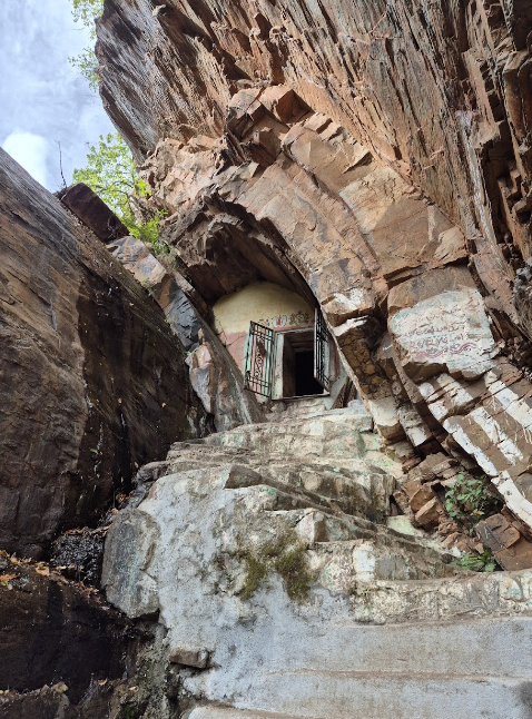 Steep rock-cut steps leading to Prahaladha Badi cave