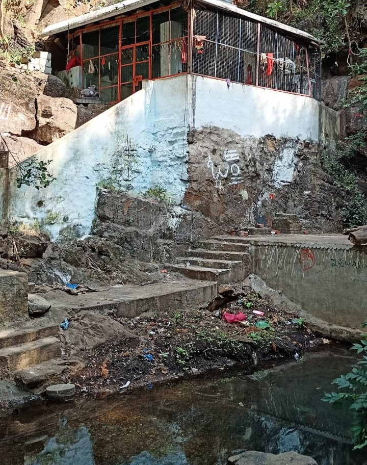 Small white temple at the base of the hill